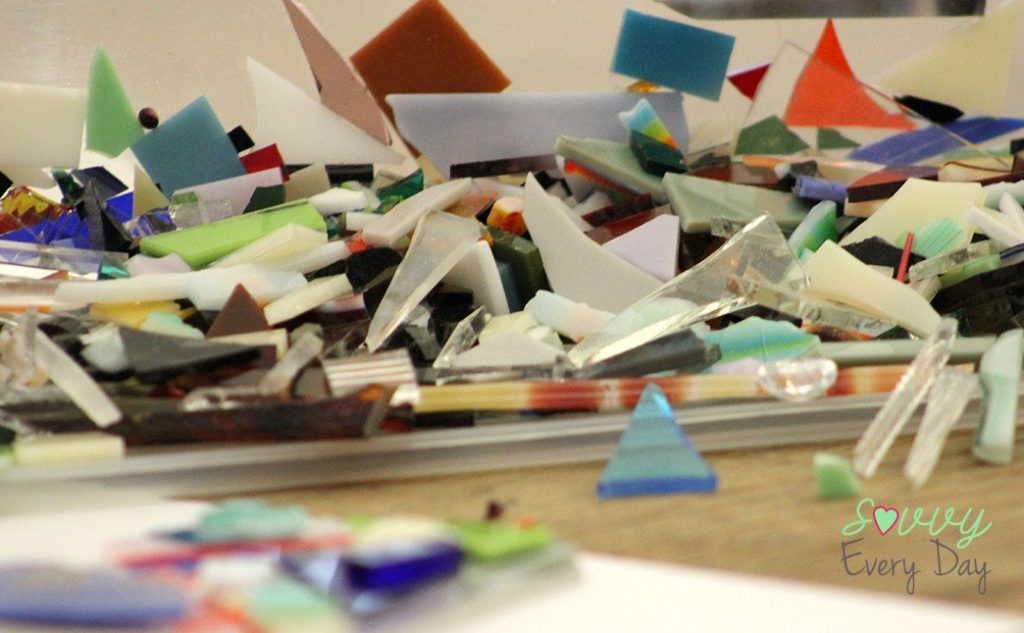 We were given bins with little pieces of glass of different colors to apply to our clear glass square.