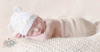 newborn sleeping on a blanket