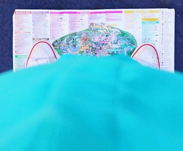 pregnant belly standing over Disneyland map