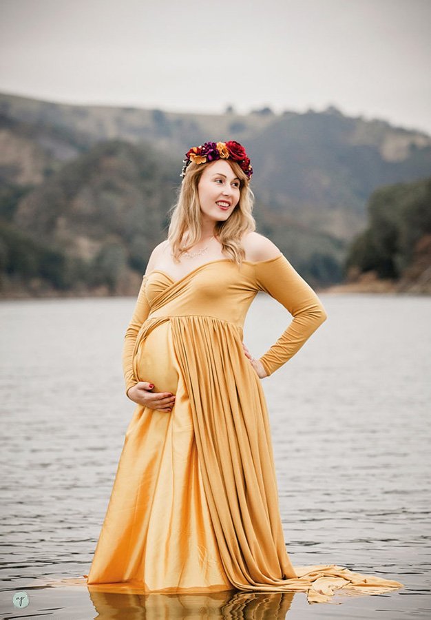 smiling expectant mom in water maternity photo