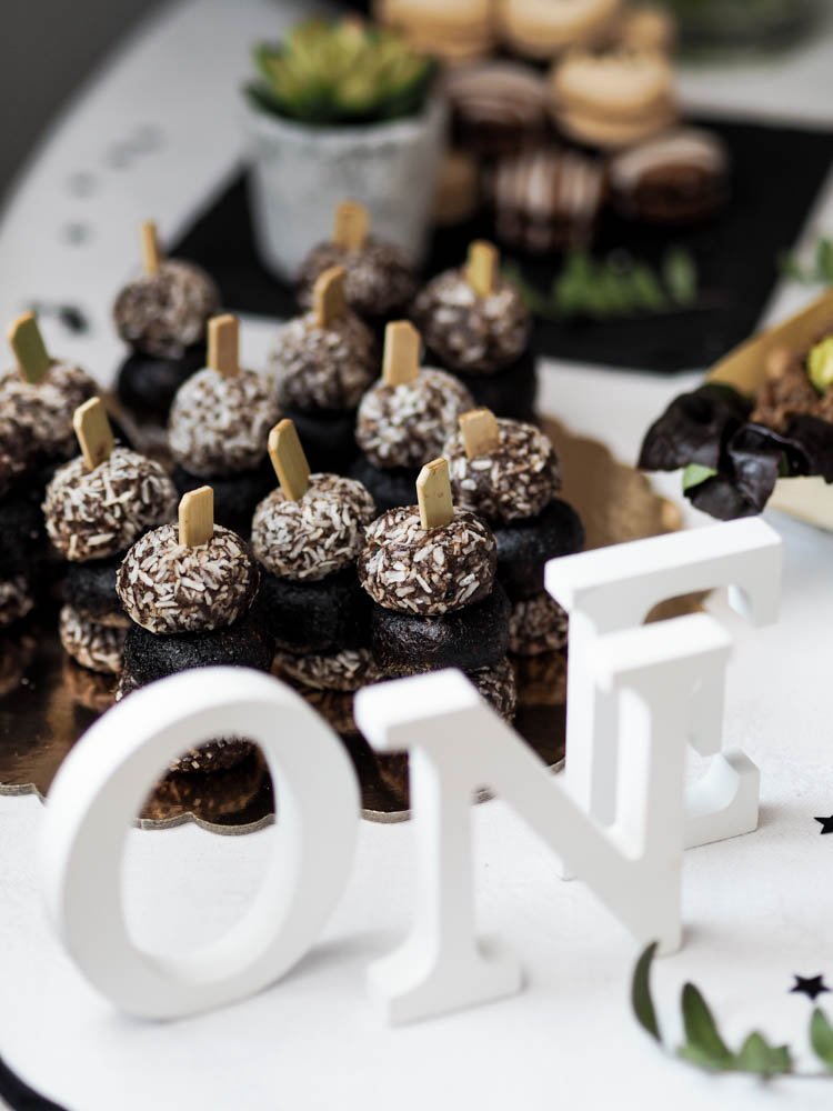 Tray of dessert and sign that says "One"