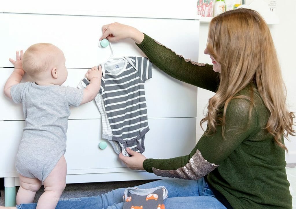 River helps hang up Gerber onesies
