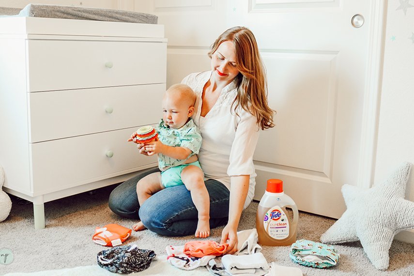 folding diapers and sitting with River