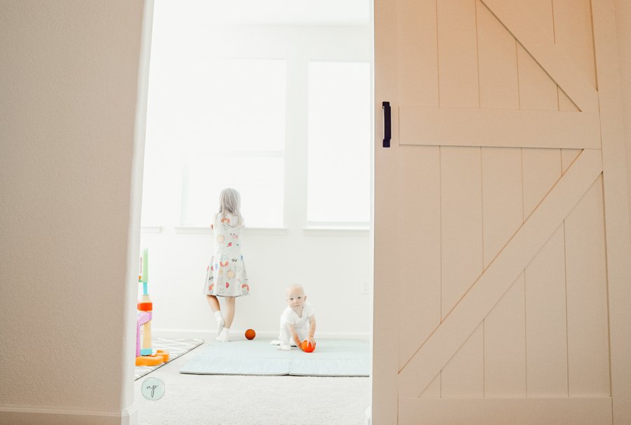 kids playing in new room view from barn door