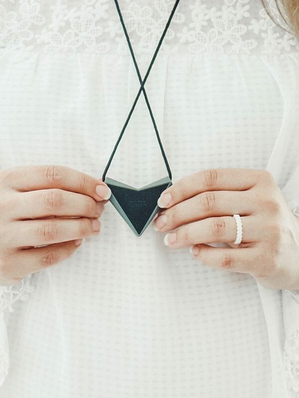 holding QALO pendant close up