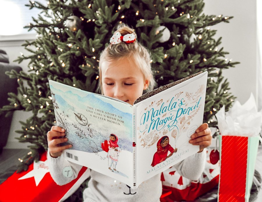 Savannah reading one of her new books from her Prime Book Box