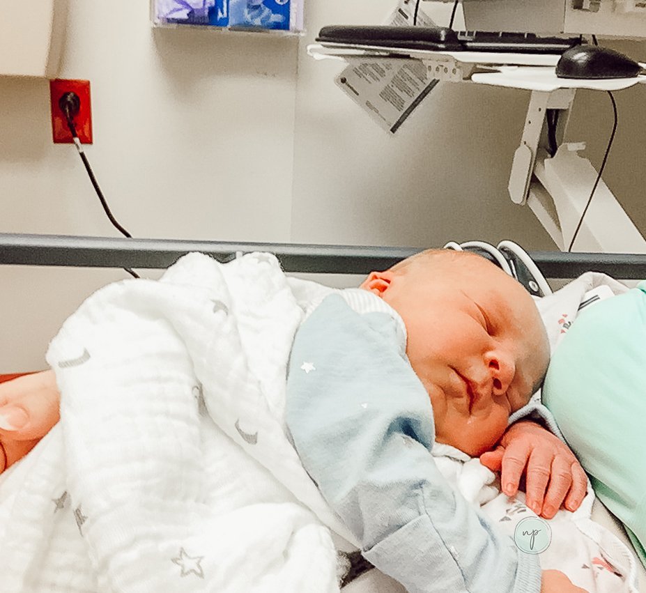 sitting in ER with newborn baby on my chest in postpartum