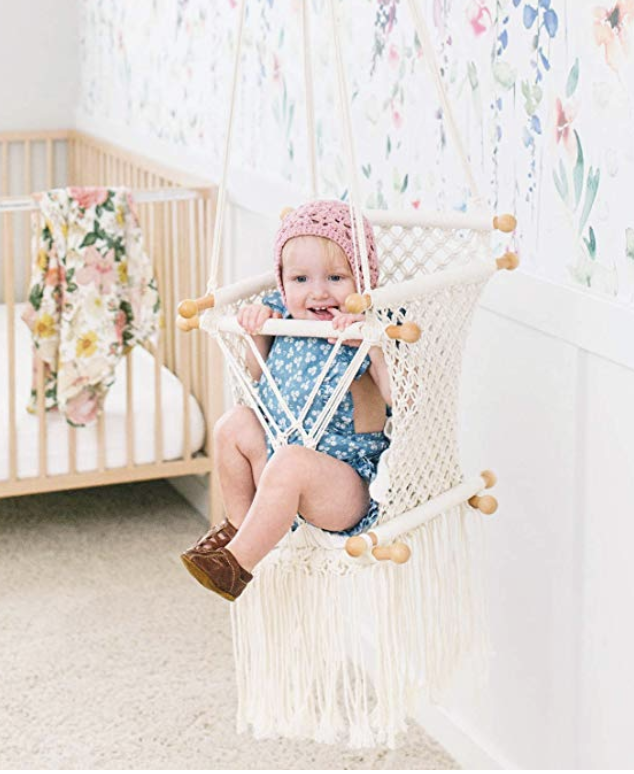Baby sitting in macrame swing