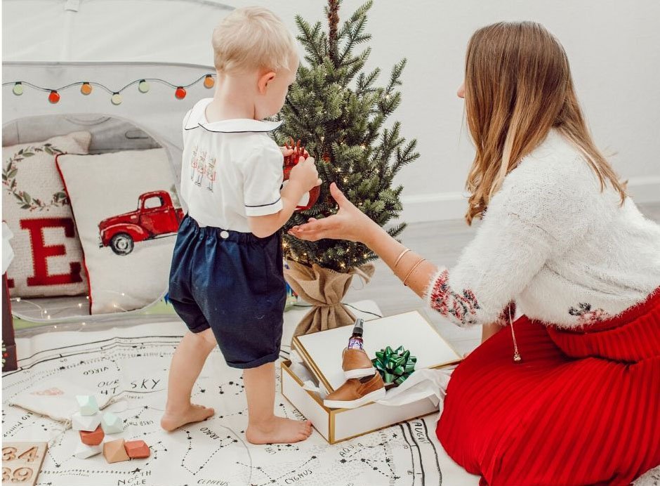 mom and toddler by mini Christmas tree