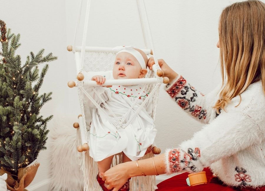 baby in macrame swing with mom holding the swing