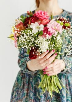Woman holding bouquet of mother's day flowers