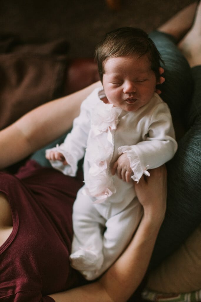mom holds sleeping baby on lap