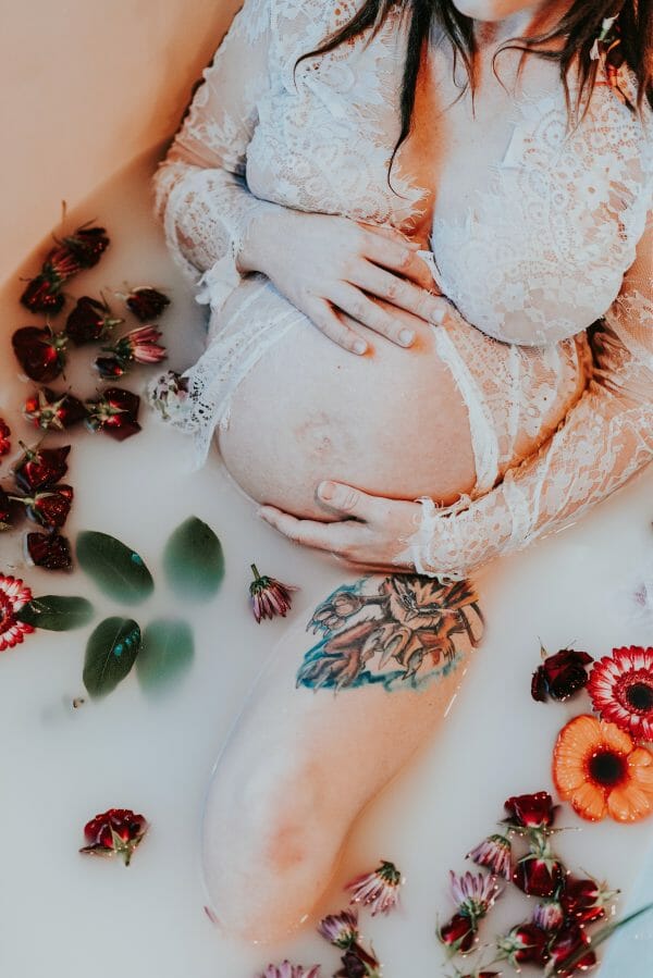 pregnant mom in floral milk bath