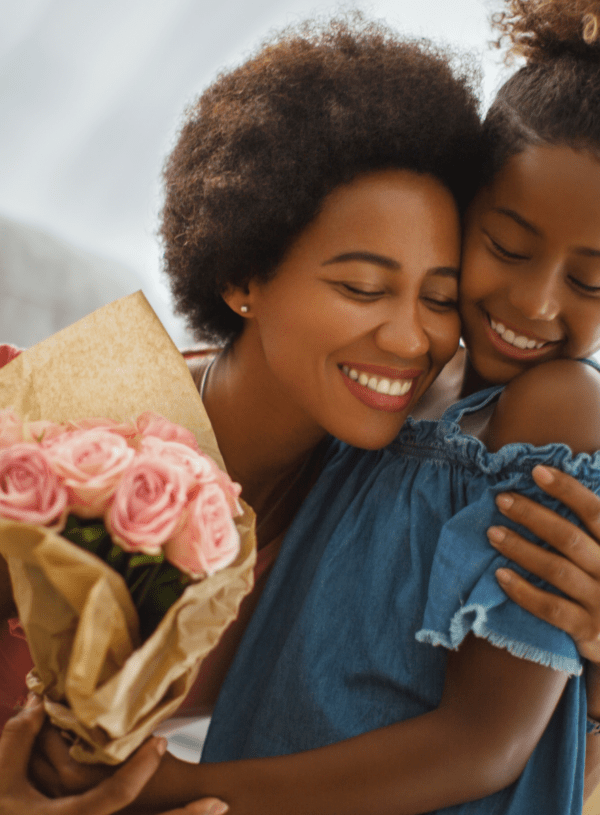 mother and daughter hug with mother’s day flower bouquet mother and daughter hug with mother's day flower bouquet