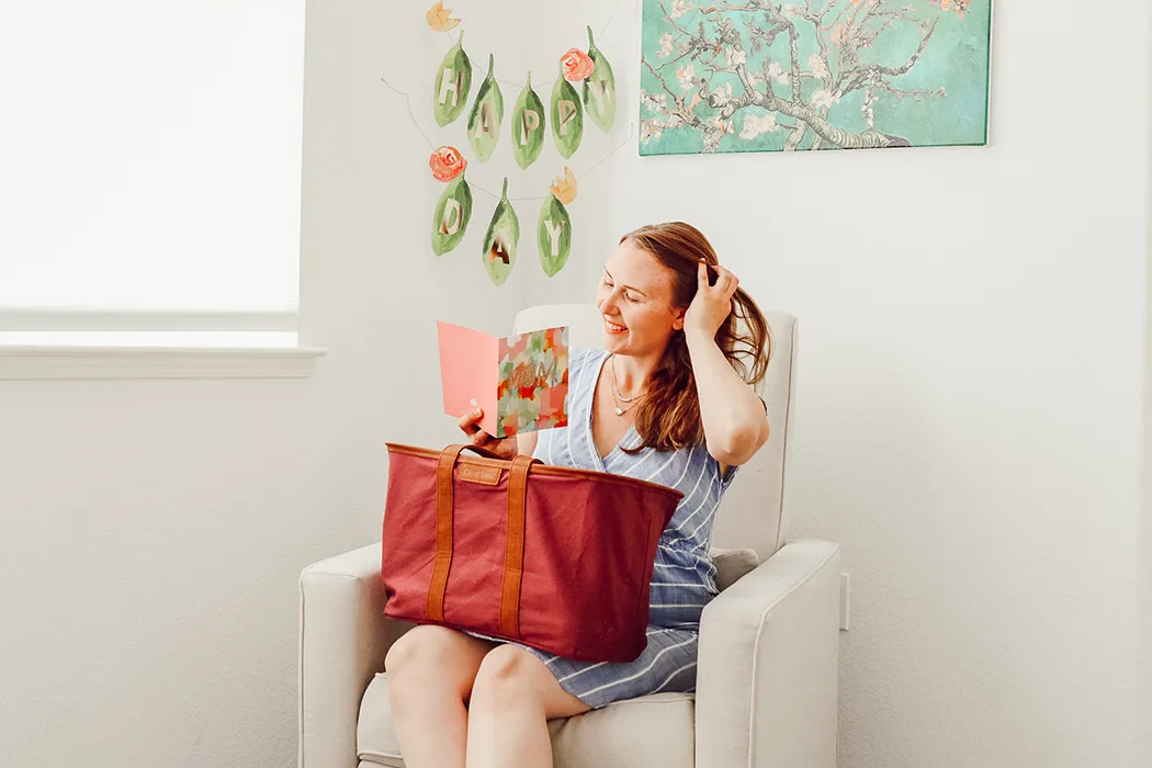 holding basket and reading Mother's Day card